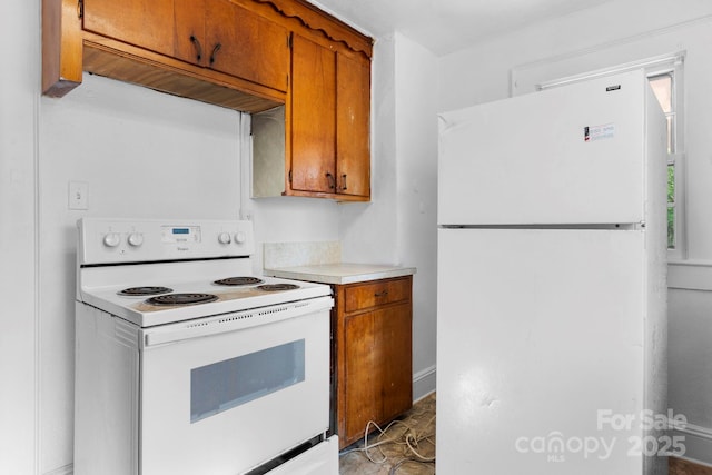 117 3rd Ave SW, Hickory, NC 28602 - kitchen featuring white appliances, brown cabinetry, and light countertops