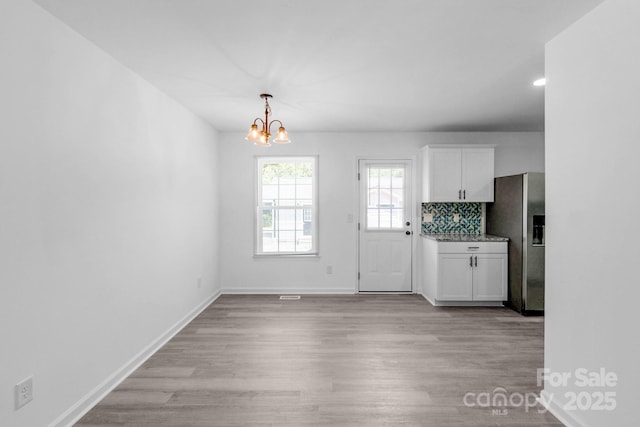 803 Evening Shade Ln, Gastonia, NC 28052 - unfurnished dining area featuring a chandelier and light wood finished floors