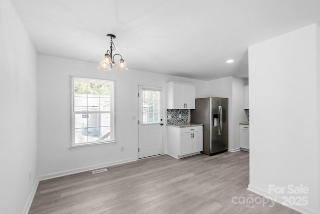 803 Evening Shade Ln, Gastonia, NC 28052 - kitchen featuring stainless steel fridge with ice dispenser, white cabinets, a chandelier, light wood finished floors, and recessed lighting