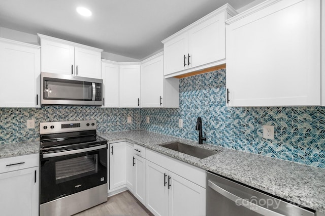 803 Evening Shade Ln, Gastonia, NC 28052 - kitchen with stainless steel appliances, white cabinetry, and light stone countertops