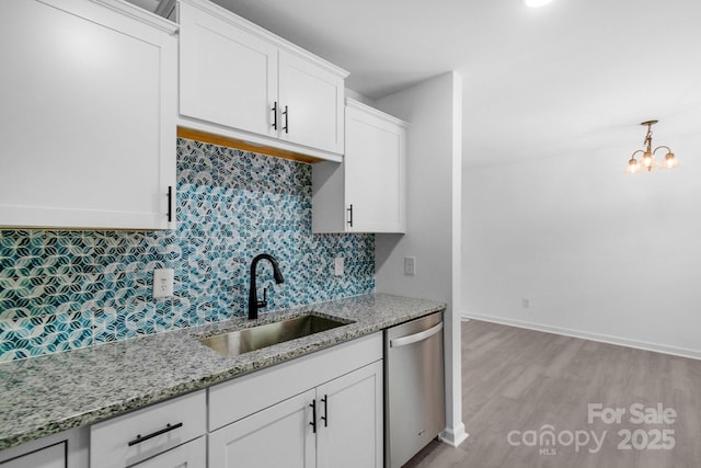 803 Evening Shade Ln, Gastonia, NC 28052 - kitchen with stainless steel dishwasher, light wood-style floors, backsplash, white cabinetry, and light stone countertops