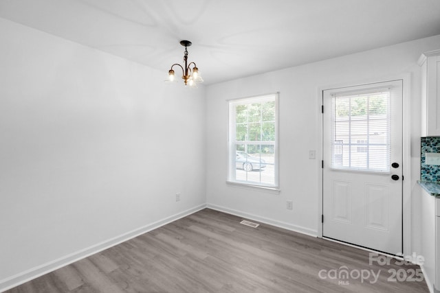 803 Evening Shade Ln, Gastonia, NC 28052 - unfurnished dining area featuring wood finished floors and a chandelier