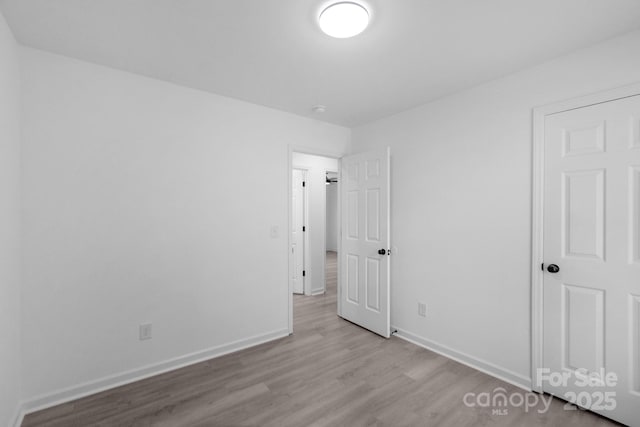 803 Evening Shade Ln, Gastonia, NC 28052 - unfurnished bedroom with wood finished floors and baseboards