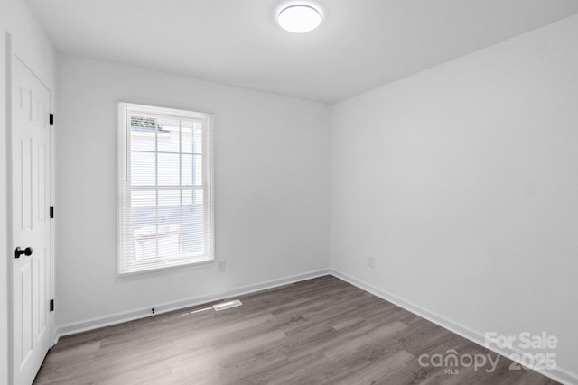 803 Evening Shade Ln, Gastonia, NC 28052 - unfurnished bedroom featuring wood finished floors and baseboards