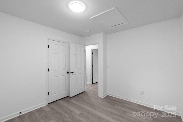 803 Evening Shade Ln, Gastonia, NC 28052 - unfurnished bedroom with wood finished floors, a closet, and attic access