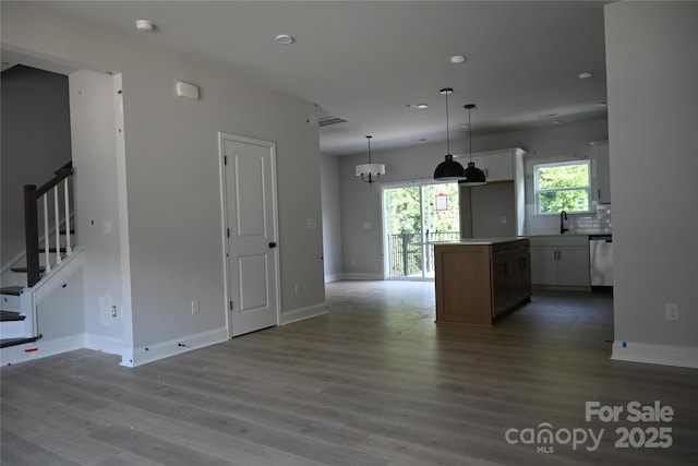 185 Cherry Springs Ln Unit 24-C, Asheville, NC 28804 - kitchen featuring stainless steel dishwasher, wood finished floors, recessed lighting, white cabinets, and hanging light fixtures