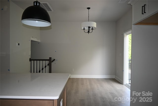 185 Cherry Springs Ln Unit 24-C, Asheville, NC 28804 - unfurnished dining area featuring light wood-style floors and baseboards