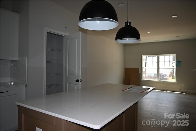 185 Cherry Springs Ln Unit 24-C, Asheville, NC 28804 - kitchen featuring open floor plan, light countertops, a center island, and hanging light fixtures