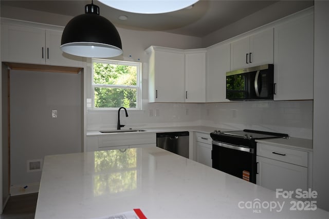 185 Cherry Springs Ln Unit 24-C, Asheville, NC 28804 - kitchen featuring stainless steel appliances, tasteful backsplash, white cabinetry, and decorative light fixtures