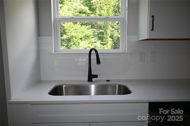 185 Cherry Springs Ln Unit 24-C, Asheville, NC 28804 - kitchen view of white cabinetry, tasteful backsplash, light stone counters, and dishwashing machine