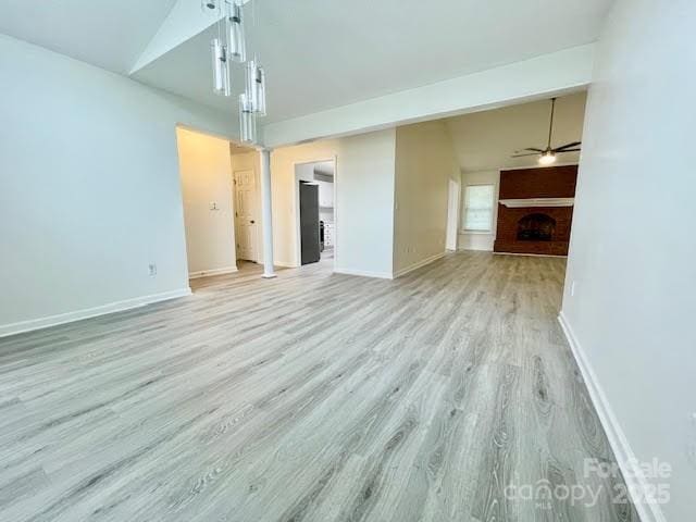 205 Hidden Spring Dr, Salisbury, NC 28147 - unfurnished living room with light wood-style flooring, a fireplace, and ceiling fan
