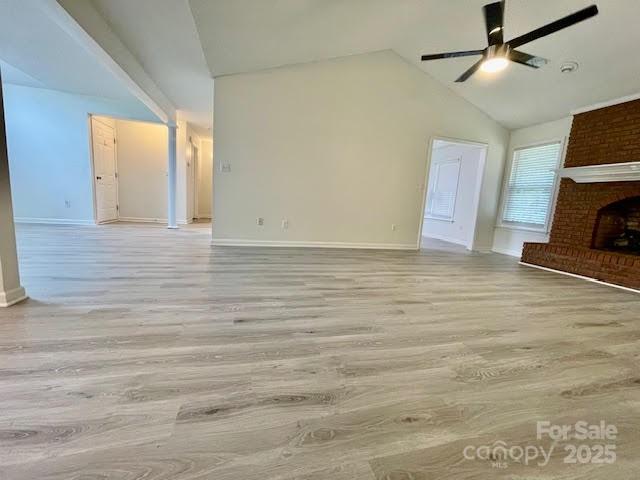 205 Hidden Spring Dr, Salisbury, NC 28147 - unfurnished living room featuring ceiling fan, lofted ceiling, light wood-style floors, and a fireplace