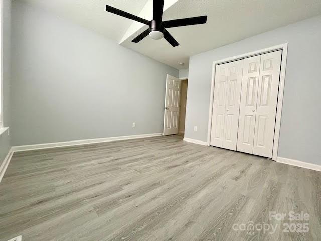 205 Hidden Spring Dr, Salisbury, NC 28147 - unfurnished bedroom featuring wood finished floors, a closet, and a ceiling fan