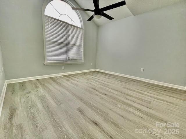 205 Hidden Spring Dr, Salisbury, NC 28147 - empty room featuring vaulted ceiling, wood finished floors, and ceiling fan