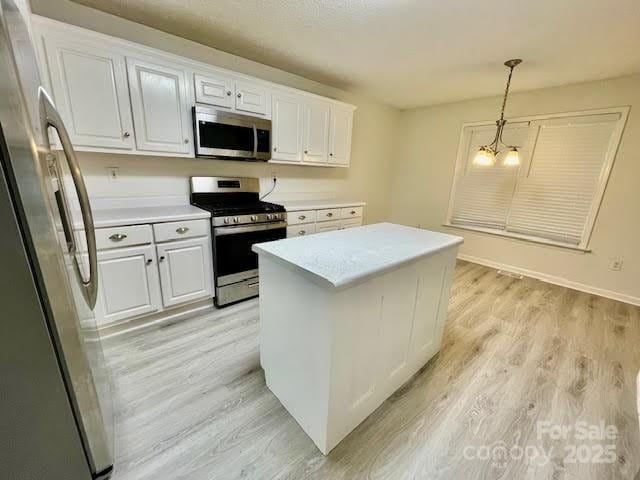 205 Hidden Spring Dr, Salisbury, NC 28147 - kitchen featuring appliances with stainless steel finishes, light wood finished floors, white cabinets, and light countertops