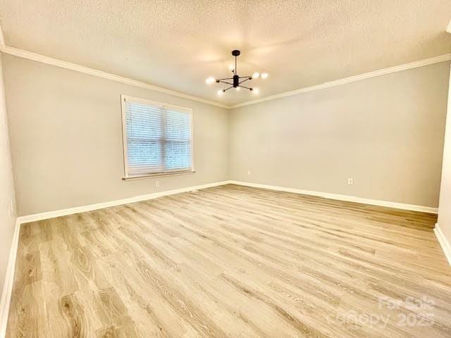 205 Hidden Spring Dr, Salisbury, NC 28147 - empty room with a chandelier, ornamental molding, light wood-type flooring, and a textured ceiling