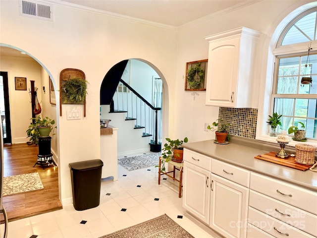 227 Reep Dr, Morganton, NC 28655 - interior space with arched walkways, stairs, ornamental molding, tasteful backsplash, and light tile patterned floors
