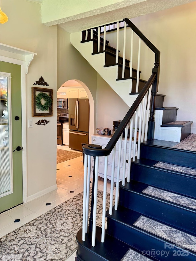 227 Reep Dr, Morganton, NC 28655 - stairway with arched walkways and tile patterned flooring