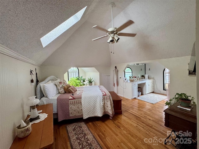 227 Reep Dr, Morganton, NC 28655 - bedroom with a skylight, a textured ceiling, wood finished floors, multiple windows, and lofted ceiling