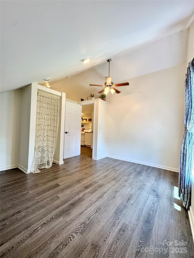 227 Reep Dr, Morganton, NC 28655 - unfurnished living room with a ceiling fan, dark wood-type flooring, and vaulted ceiling