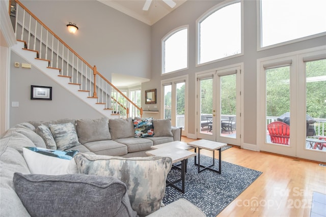 9221 Belle Pines Ct, Sherrills Ford, NC 28673 - living room featuring wood finished floors, stairs, a high ceiling, ceiling fan, and crown molding