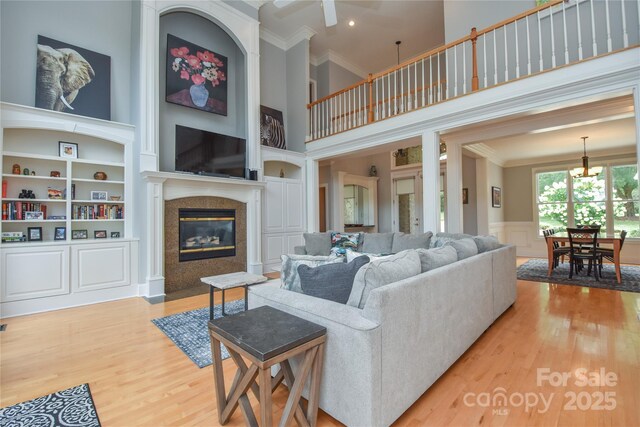 9221 Belle Pines Ct, Sherrills Ford, NC 28673 - living area with ornamental molding, a high ceiling, wood finished floors, a chandelier, and a high end fireplace