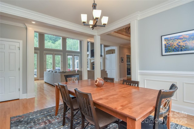 9221 Belle Pines Ct, Sherrills Ford, NC 28673 - dining room with a chandelier, ornamental molding, light wood-style floors, and a wainscoted wall
