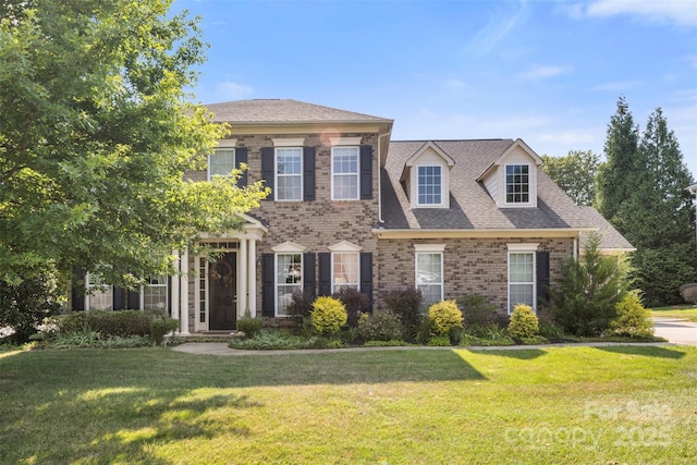 1204 Vaugelas Ct, Monroe, NC 28110 - view of front facade featuring a front lawn, brick siding, and roof with shingles
