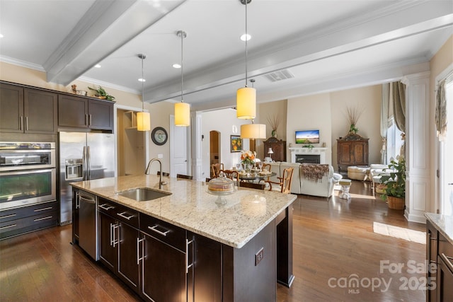 1204 Vaugelas Ct, Monroe, NC 28110 - kitchen featuring beam ceiling, dark wood-style flooring, stainless steel appliances, dark brown cabinetry, and decorative light fixtures