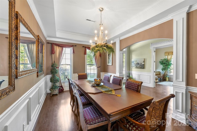 1204 Vaugelas Ct, Monroe, NC 28110 - dining area featuring arched walkways, ornate columns, a decorative wall, wainscoting, and a chandelier