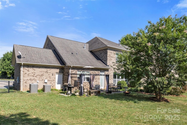 1204 Vaugelas Ct, Monroe, NC 28110 - back of property with a gazebo, an outdoor fire pit, brick siding, and roof with shingles