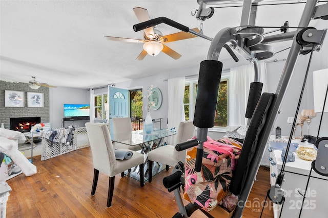 107 Laura Springs Dr, Salisbury, NC 28146 - dining room featuring ceiling fan, a brick fireplace, and wood finished floors