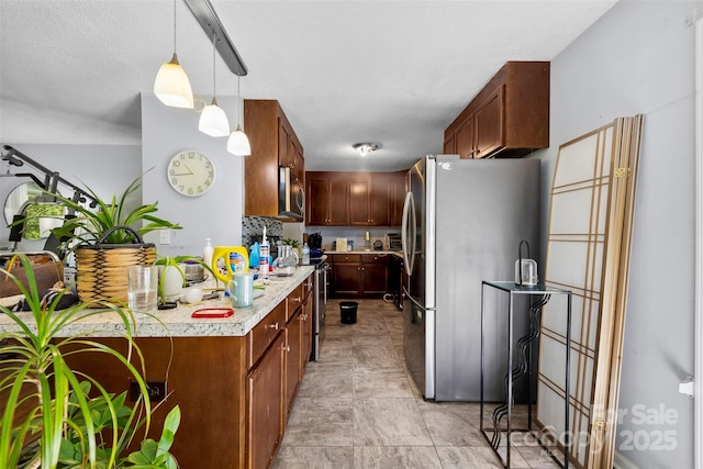 107 Laura Springs Dr, Salisbury, NC 28146 - kitchen featuring appliances with stainless steel finishes, light countertops, and pendant lighting