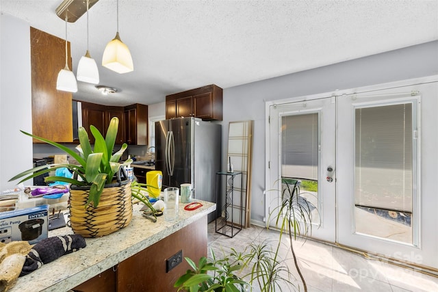 107 Laura Springs Dr, Salisbury, NC 28146 - kitchen with light countertops, freestanding refrigerator, french doors, pendant lighting, and a textured ceiling