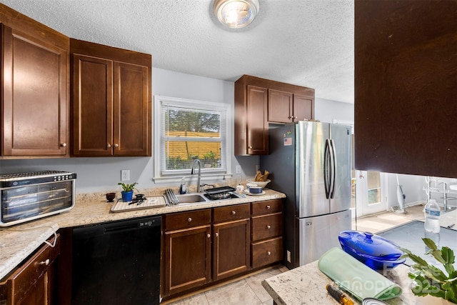 107 Laura Springs Dr, Salisbury, NC 28146 - kitchen featuring dishwasher, freestanding refrigerator, a textured ceiling, and light stone countertops