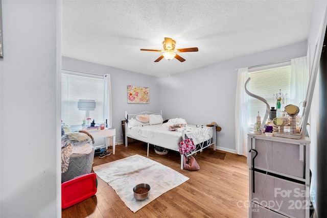 107 Laura Springs Dr, Salisbury, NC 28146 - bedroom featuring wood finished floors, a textured ceiling, and a ceiling fan