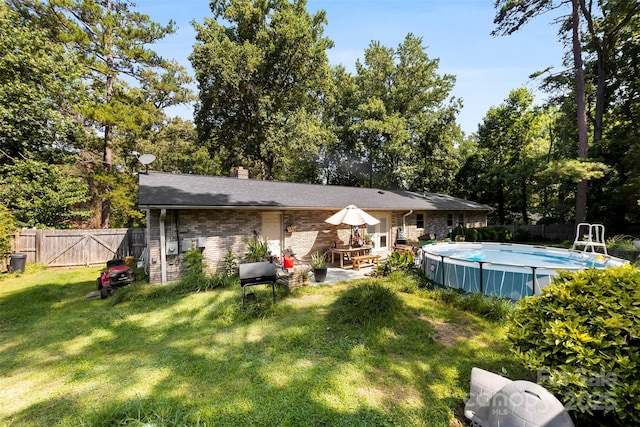 107 Laura Springs Dr, Salisbury, NC 28146 - back of house with a fenced backyard, a chimney, a patio area, brick siding, and a gate