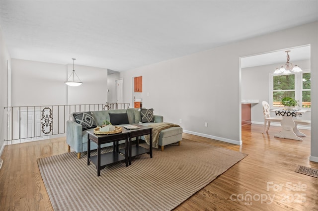 15 Beaverdam Ct, Asheville, NC 28804 - living area featuring a chandelier and light wood finished floors