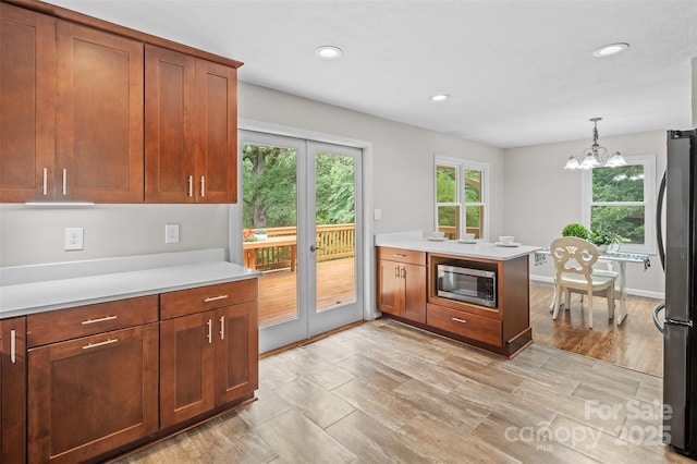 15 Beaverdam Ct, Asheville, NC 28804 - kitchen with stainless steel appliances, light countertops, a chandelier, recessed lighting, and hanging light fixtures