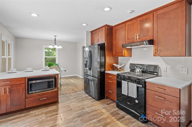 15 Beaverdam Ct, Asheville, NC 28804 - kitchen featuring stainless steel appliances, under cabinet range hood, light countertops, brown cabinetry, and recessed lighting