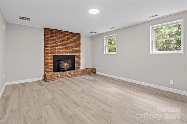 15 Beaverdam Ct, Asheville, NC 28804 - unfurnished living room featuring wood finished floors and a wood stove