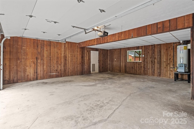 15 Beaverdam Ct, Asheville, NC 28804 - garage featuring gas water heater, wood walls, and a garage door opener