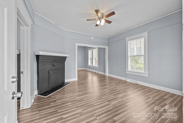 200 N Martin Luther King Jr Ave, Salisbury, NC 28144 - unfurnished living room with crown molding, ceiling fan, wood finished floors, and a brick fireplace