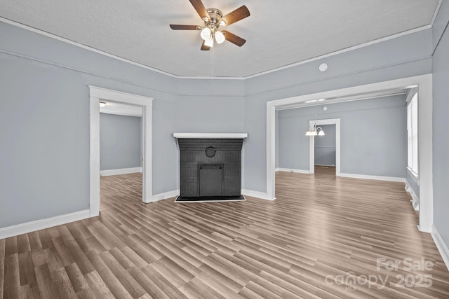 200 N Martin Luther King Jr Ave, Salisbury, NC 28144 - unfurnished living room with ceiling fan, wood finished floors, a textured ceiling, and a brick fireplace