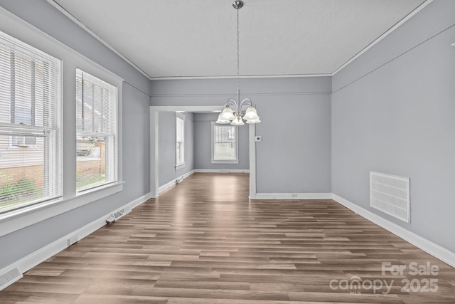 200 N Martin Luther King Jr Ave, Salisbury, NC 28144 - unfurnished dining area featuring a chandelier, plenty of natural light, wood finished floors, and ornamental molding