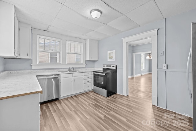 200 N Martin Luther King Jr Ave, Salisbury, NC 28144 - kitchen with appliances with stainless steel finishes, a paneled ceiling, white cabinets, light countertops, and light wood finished floors