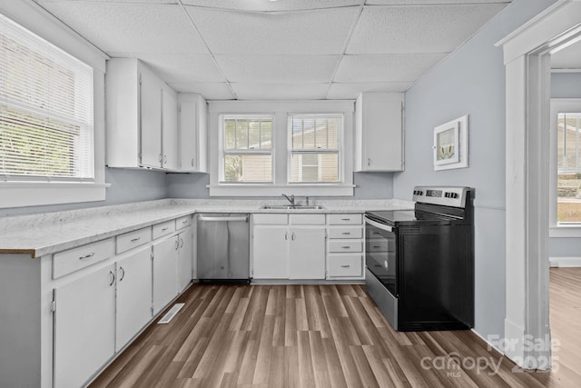 200 N Martin Luther King Jr Ave, Salisbury, NC 28144 - kitchen with appliances with stainless steel finishes, a drop ceiling, wood finished floors, light countertops, and white cabinets