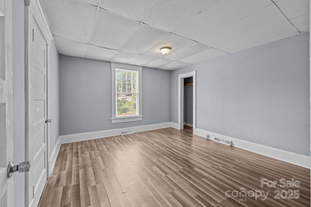 200 N Martin Luther King Jr Ave, Salisbury, NC 28144 - unfurnished bedroom featuring a drop ceiling, wood finished floors, and a closet