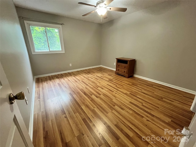 140 Lake Concord Rd NE Unit B7, Concord, NC 28025 - empty room with wood finished floors and a ceiling fan