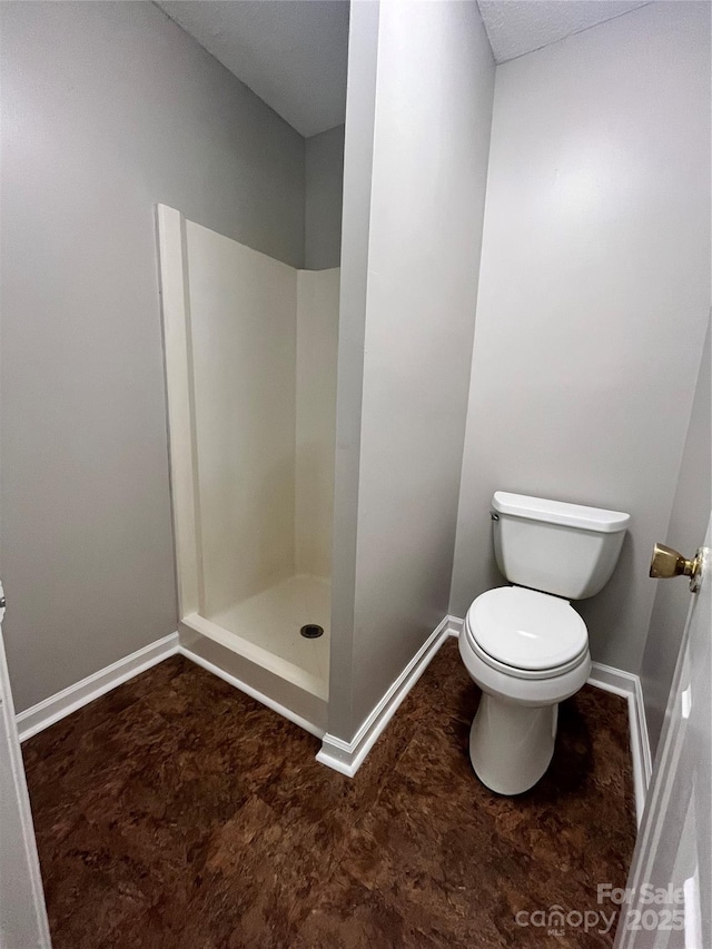 140 Lake Concord Rd NE Unit B7, Concord, NC 28025 - full bathroom featuring a stall shower and baseboards